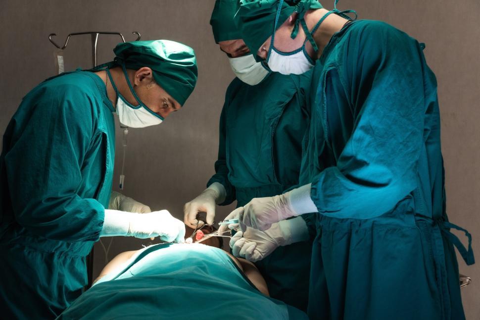 Free Image of Medical team performs surgical operation in operating room 
