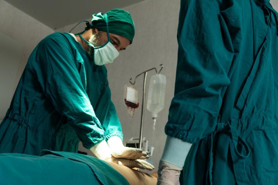 Free Image of Surgeon giving CPR to patient in operating theatre 