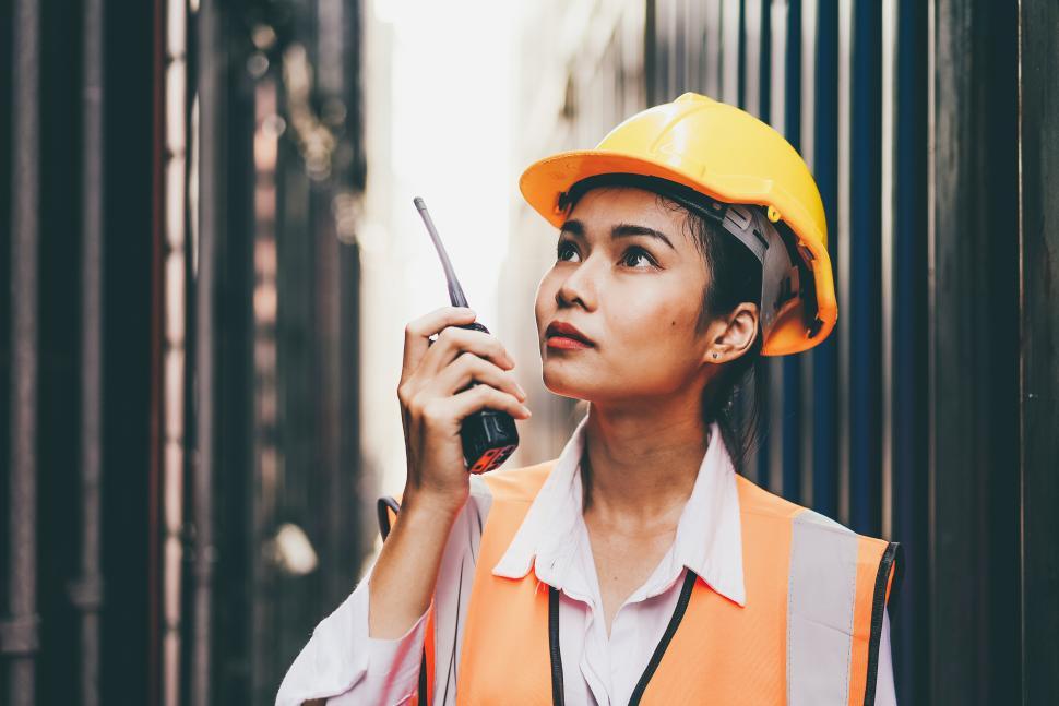 Free Image of Worker talking with walkie talkie at container warehouse 