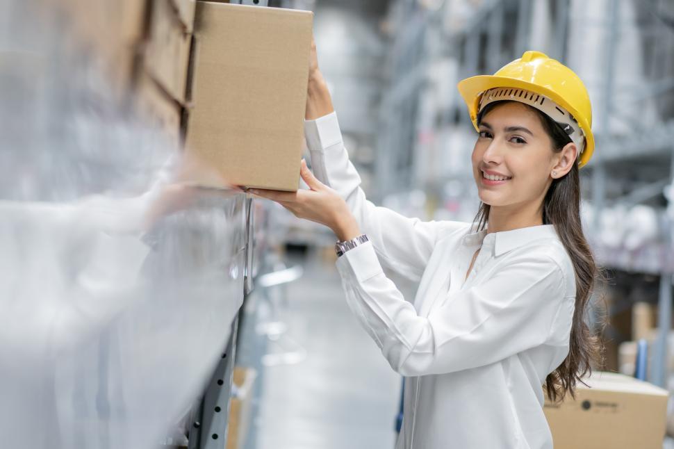 Free Image of Warehouse worker moving boxes 