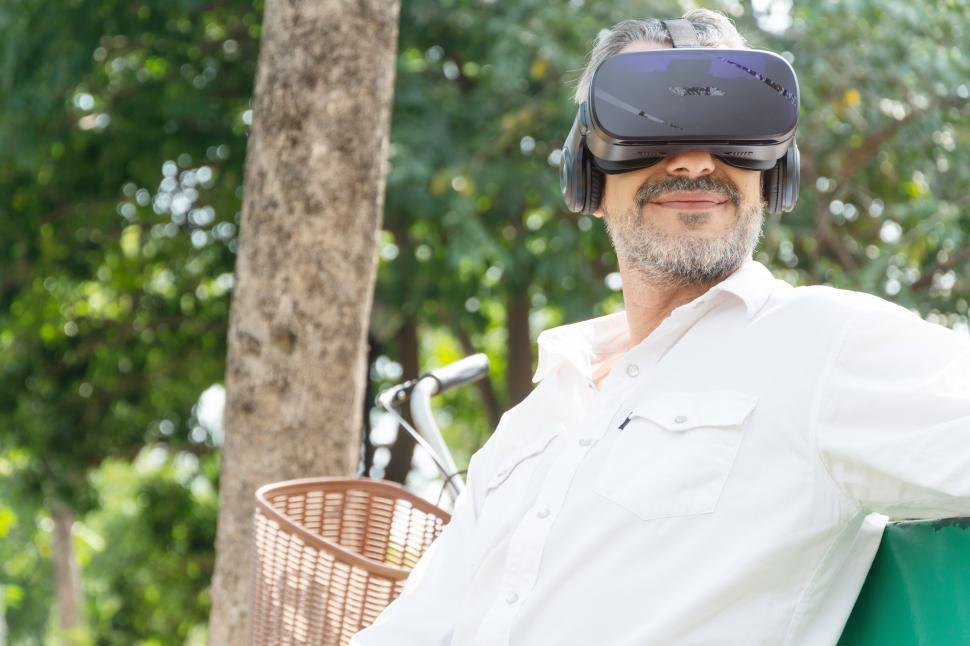 Free Image of Senior man watching movie or travel on metaverse with VR glasses 