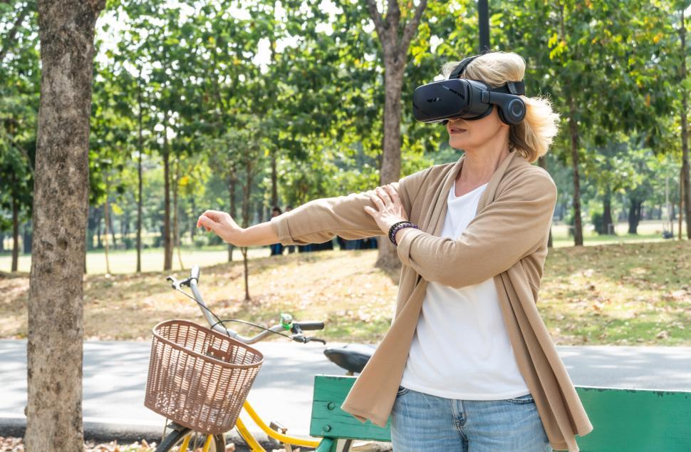 Free Image of Woman exercising while watching VR headset 
