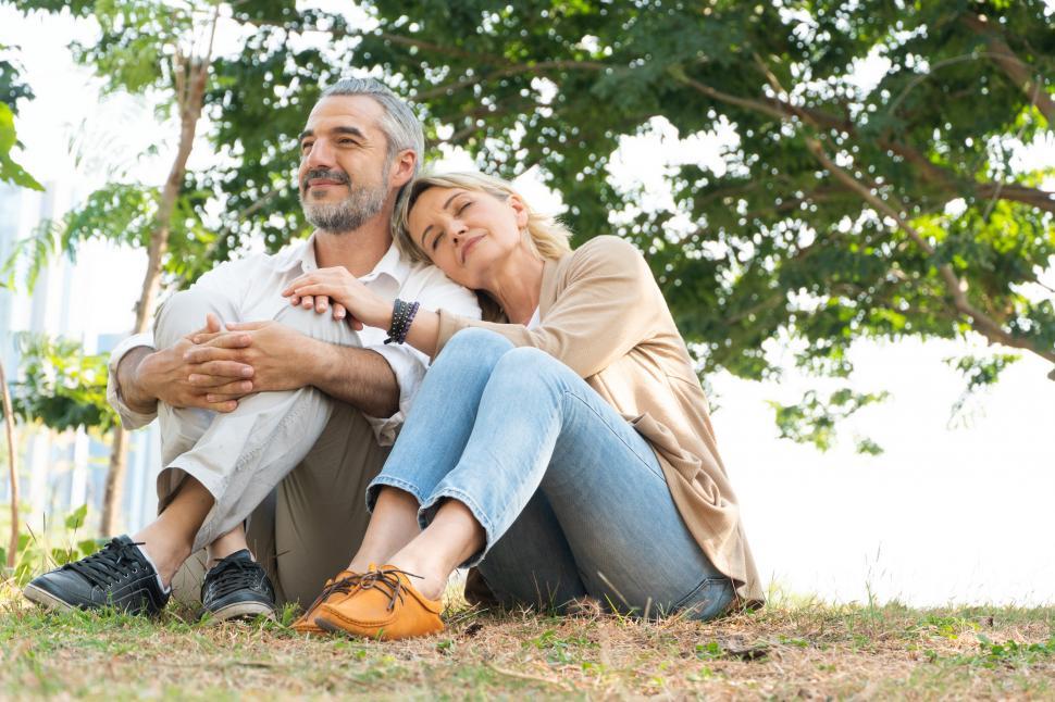 Free Image of Adult couple sitting on grass together at park 
