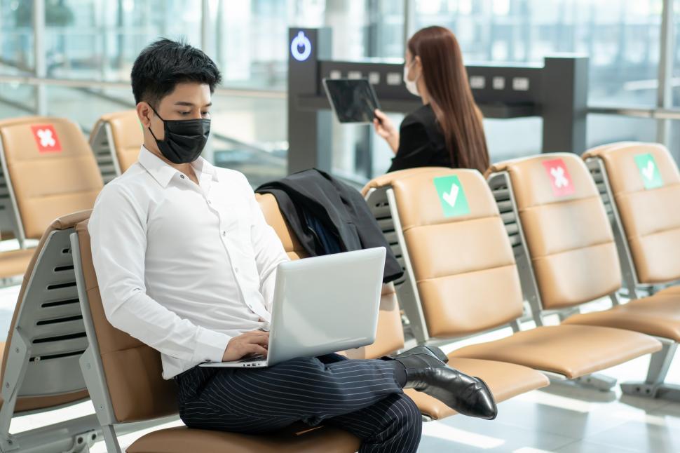 Free Image of Business man wearing medical protective mask working on laptop 