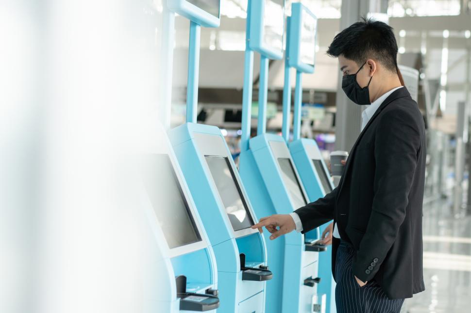 Free Image of Business man use self service check in at airport 