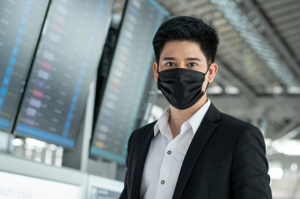 Free Image of Portrait of business man wearing protective mask in the airport 