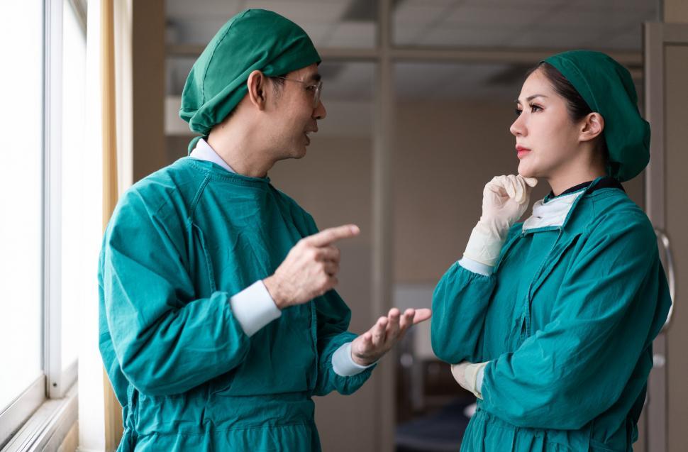 Free Image of Male and female surgeon discussing procedure 