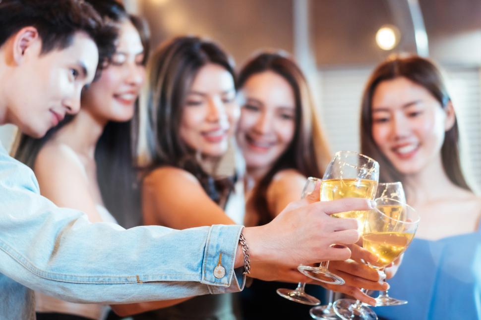 Free Image of Group of friends toasting drink at a party 
