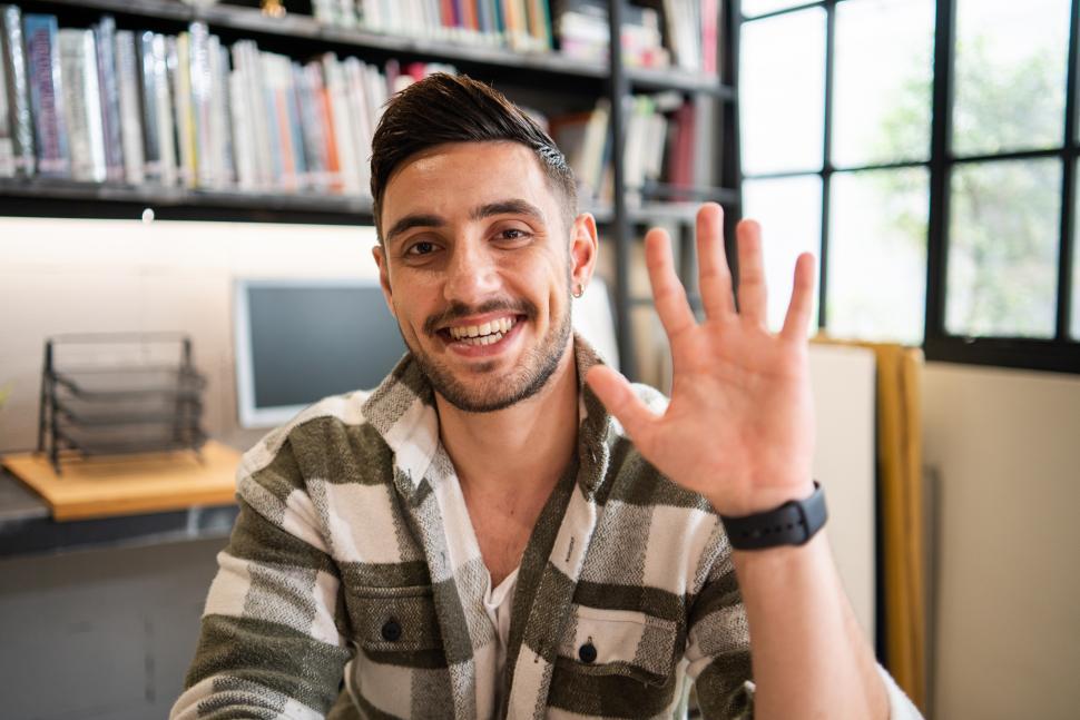 Download Free Stock Photo of Portrait of handsome young man waving hand 