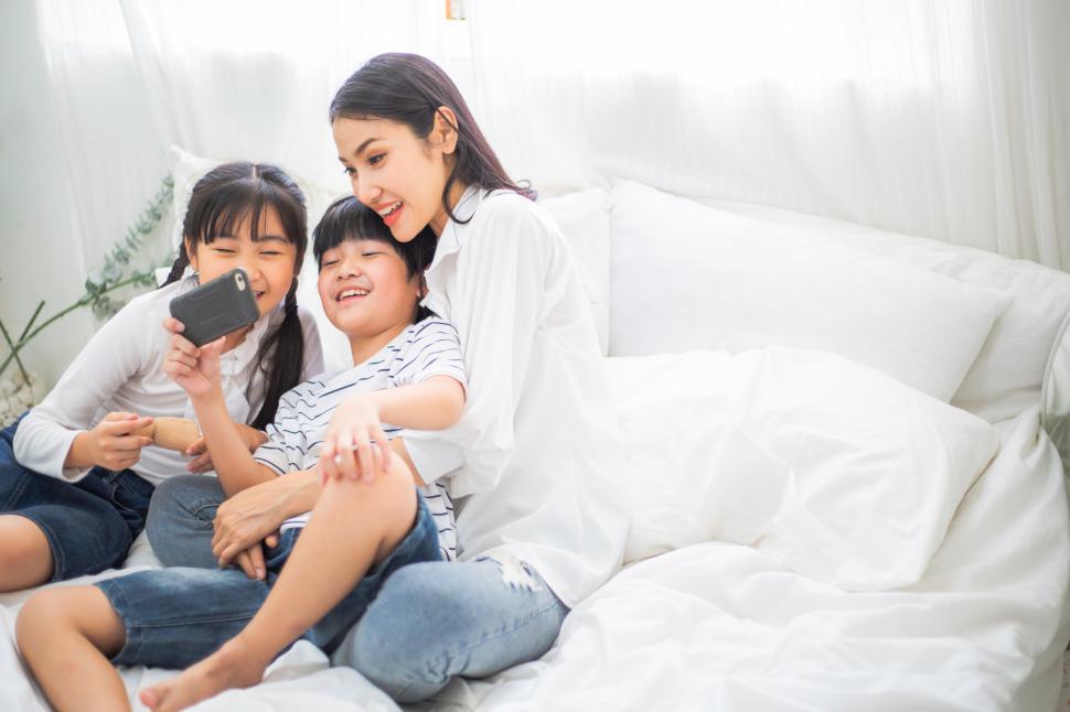 Free Image of Family watching a movie on smartphone together 