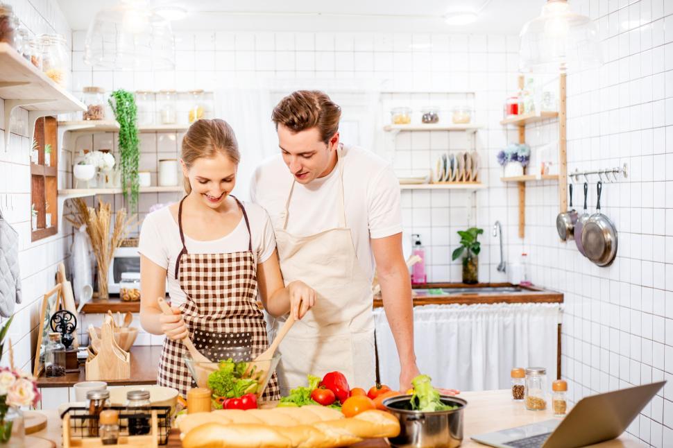 Free Image of Happy couple cooking in the kitchen together 