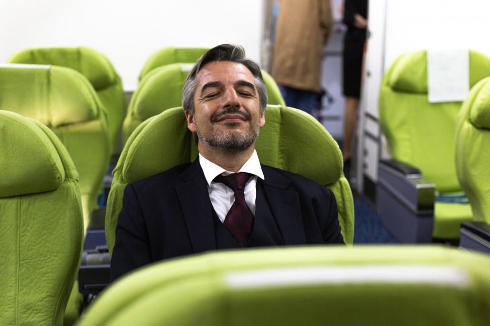 Free Image of Businessman sleeping in airplane seat 
