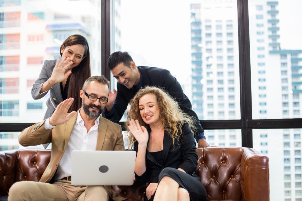 Free Image of Diverse corporate business team waving hands in virtual meeting 