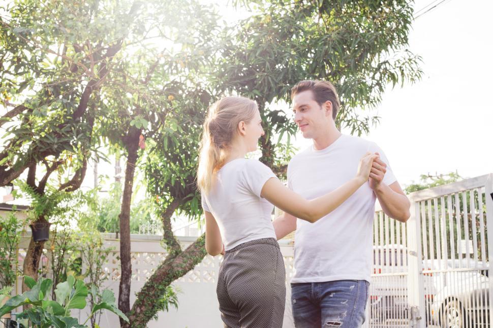 Free Image of Couple dancing together in the backyard at home 