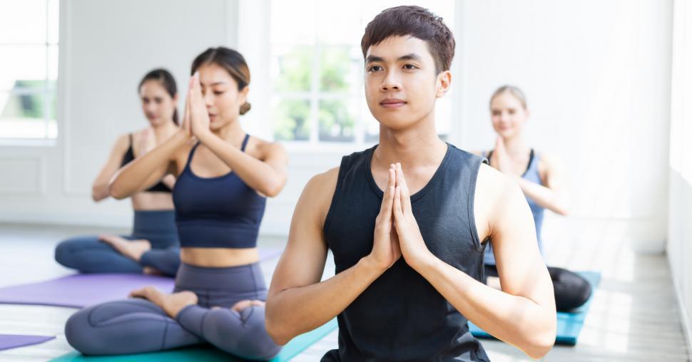 Download Free Stock Photo of Diverse group of young sporty folks learning yoga 