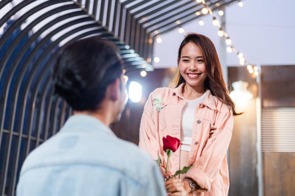 Free Image of Man giving red rose to his girlfriend for Valentines day 