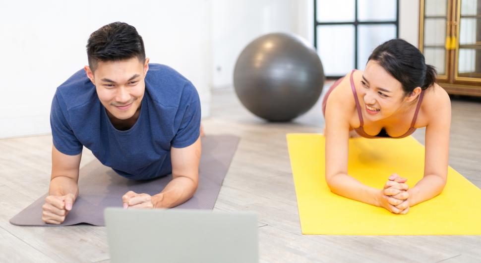 Download Free Stock Photo of Couple planking exercise on yoga mat 