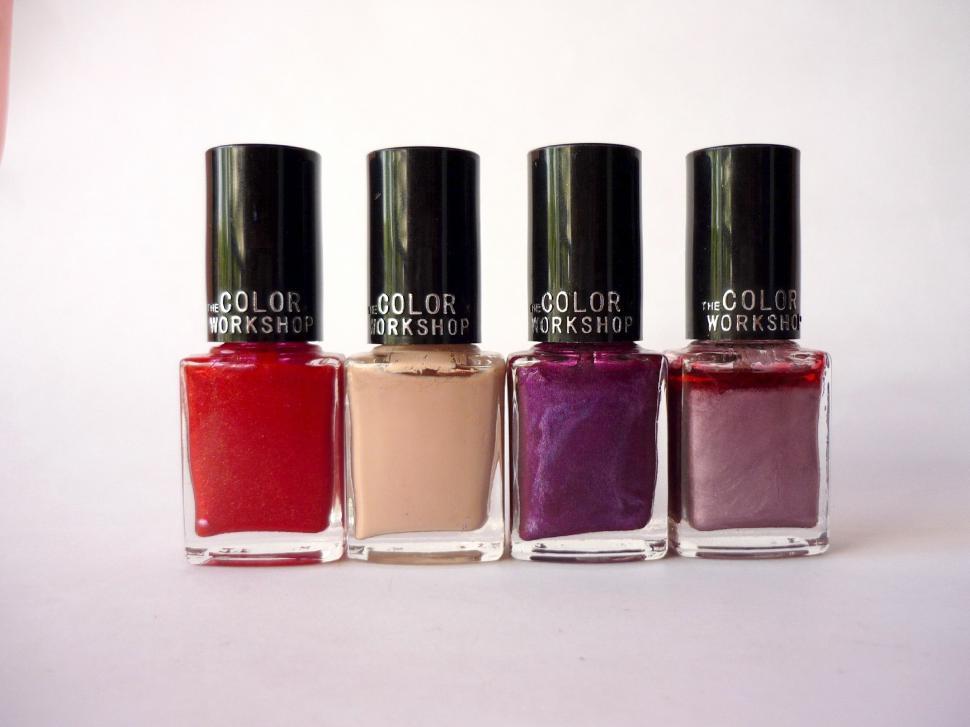 Free Image of Three Bottles of Nail Polish Side by Side 