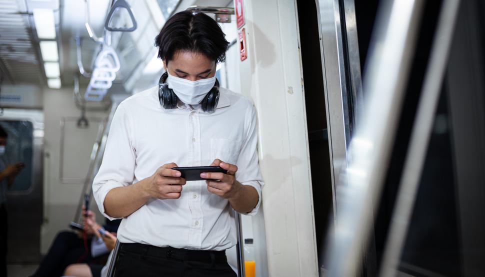 Free Image of Male passenger using smartphone on a subway car 