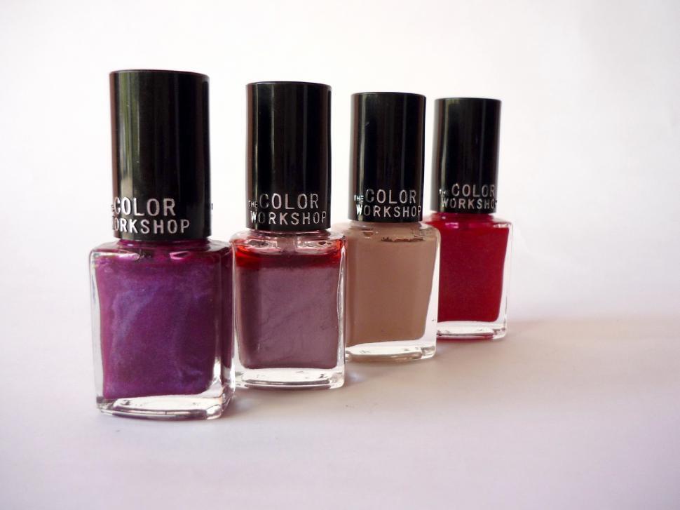 Free Image of Four Bottles of Nail Polish Arranged in a Row 
