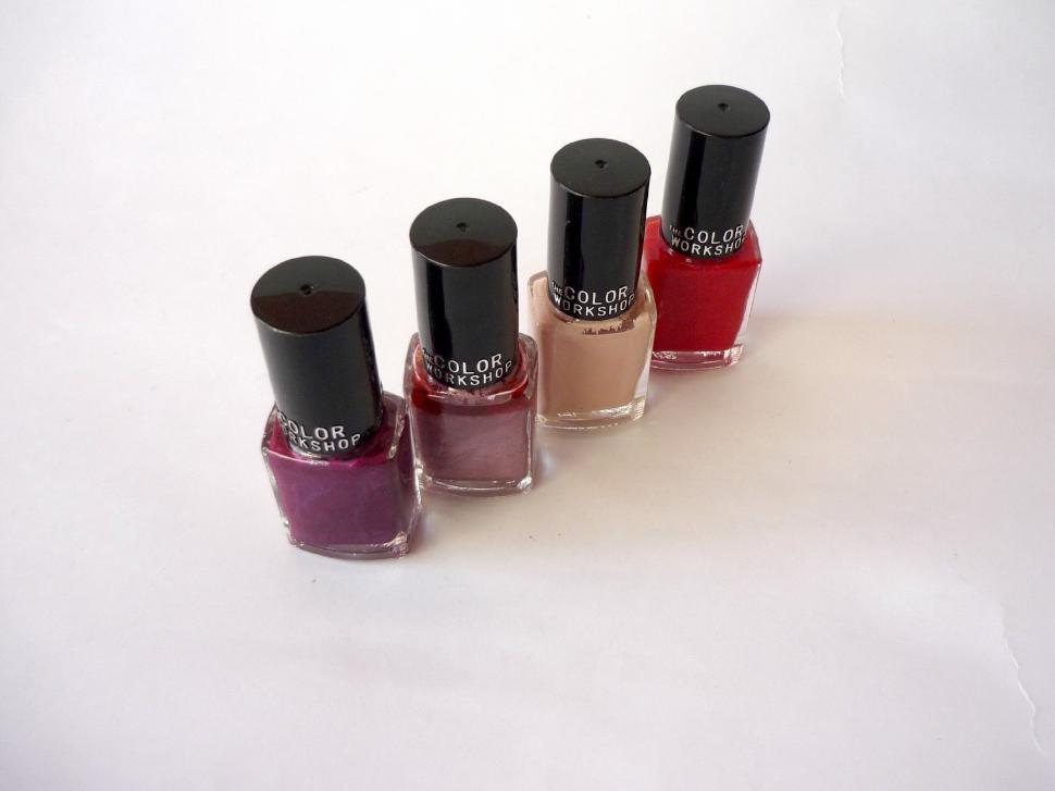 Free Image of Four Bottles of Nail Polish Arranged in a Row 