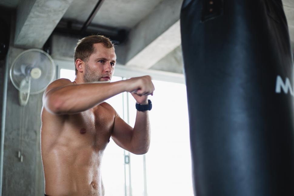 Free Image of Muscular man boxing training exercise at a fitness center 