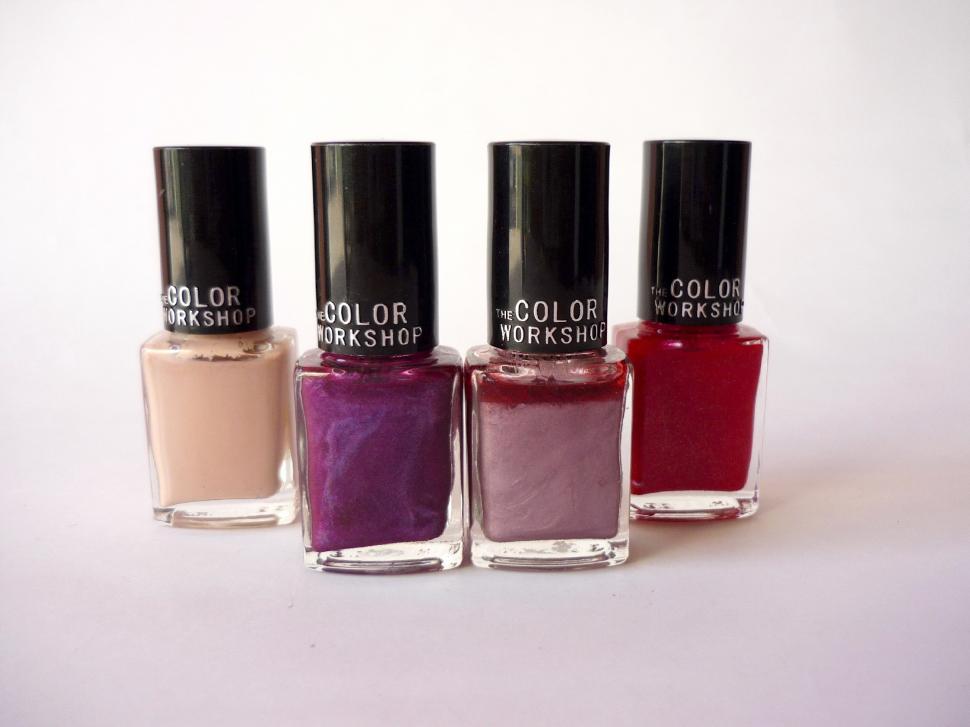 Free Image of Four Bottles of Nail Polish Arranged in a Row 