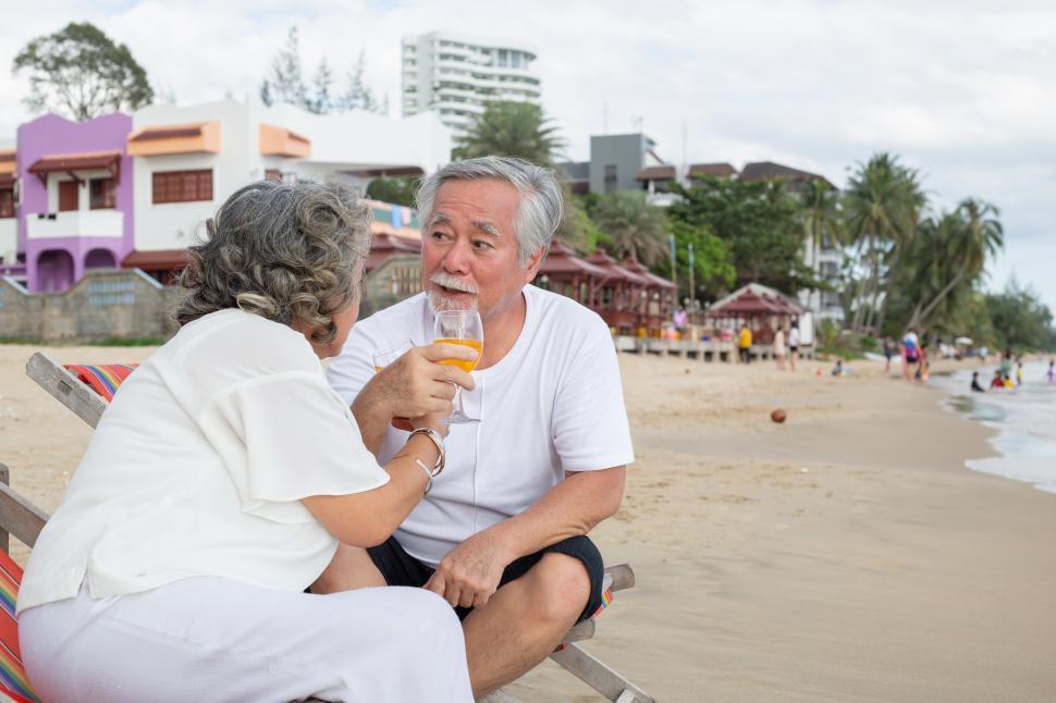 Free Image of Senior couple enjoy drinking wine, sitting and talking together 