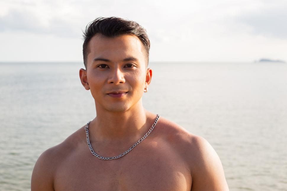 Free Image of Portrait of shirtless man at the beach, looking at the camera 