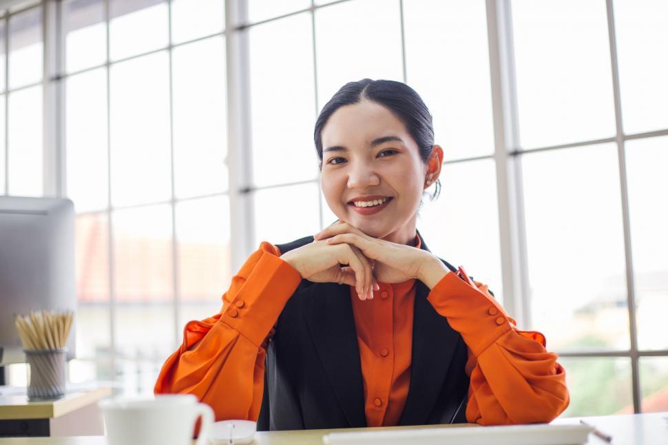 Download Free Stock Photo of Portrait of young female employee smiling at the camera 
