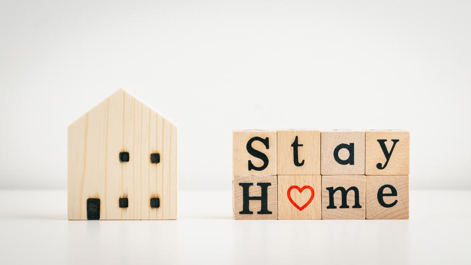 Download Free Stock Photo of Stay home message on wooden home model 
