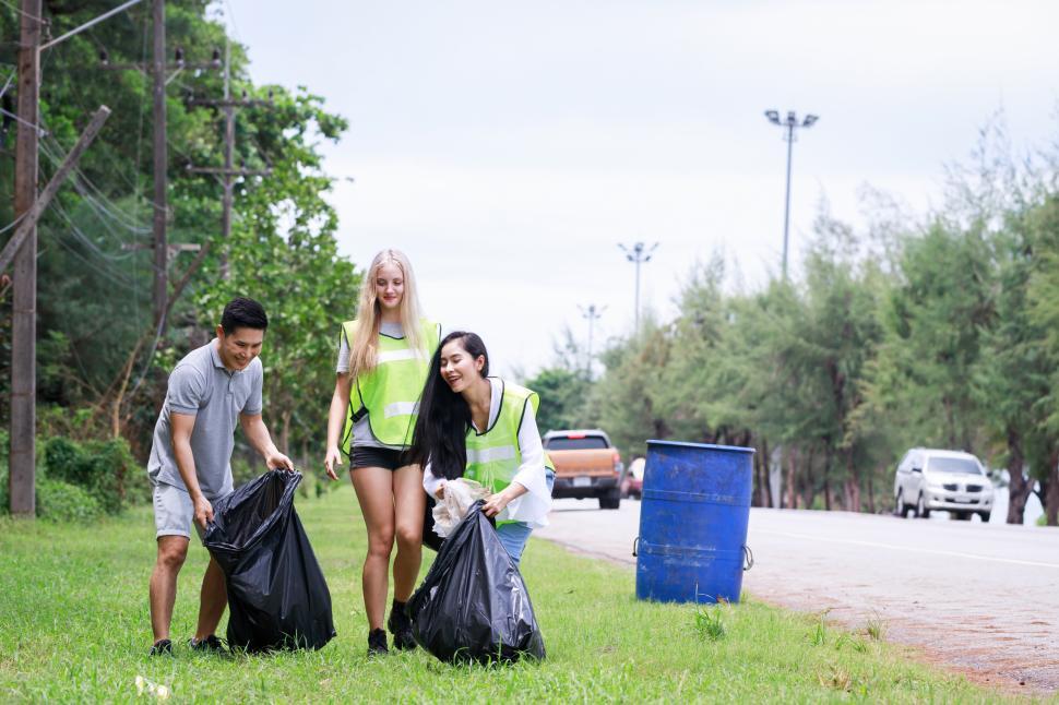 Free Image of Corporate Social Responsibility. Three CSR volunteers pick up litter. 
