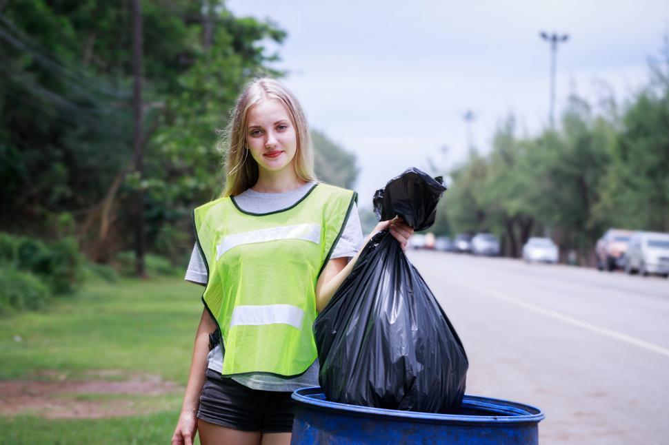 Free Image of Volunteers, Woman helping to pick up waste by public highway 