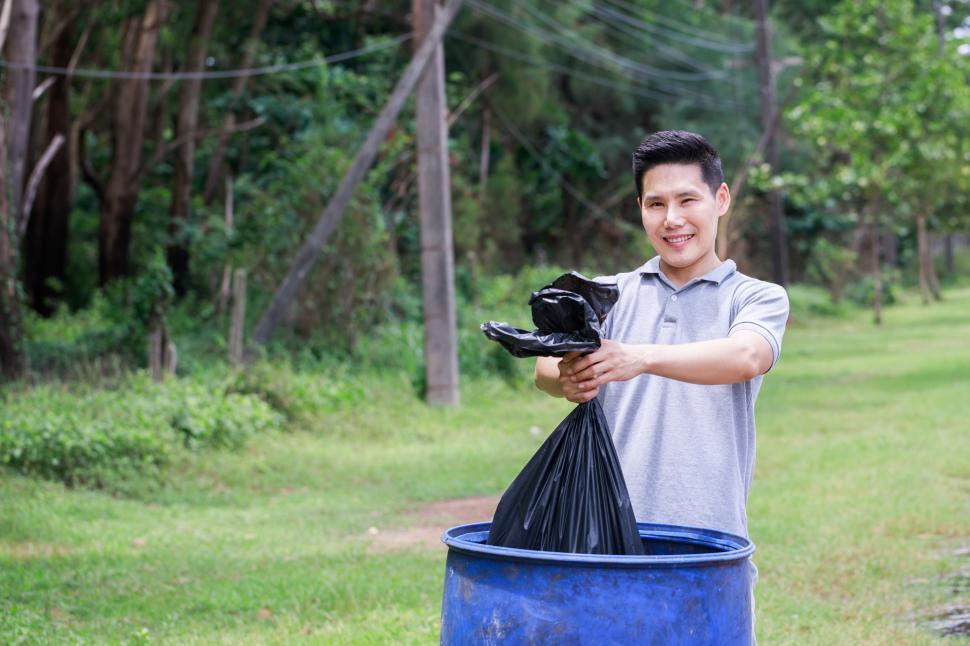 Download Free Stock Photo of Volunteers helping to pick up garbage in side of the road 