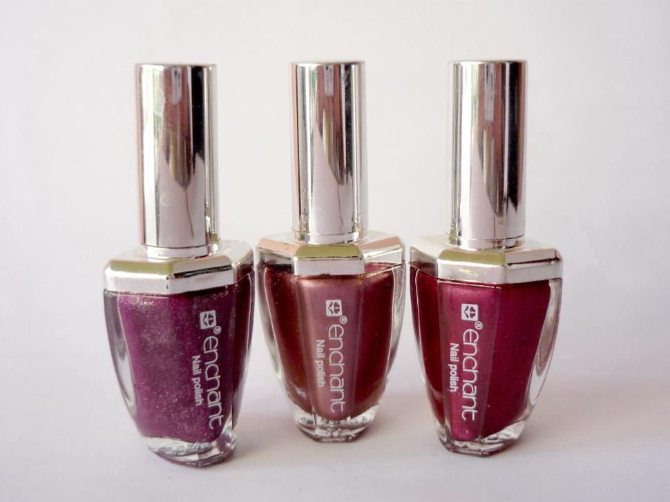 Free Image of Three Bottles of Nail Polish Arranged Neatly 