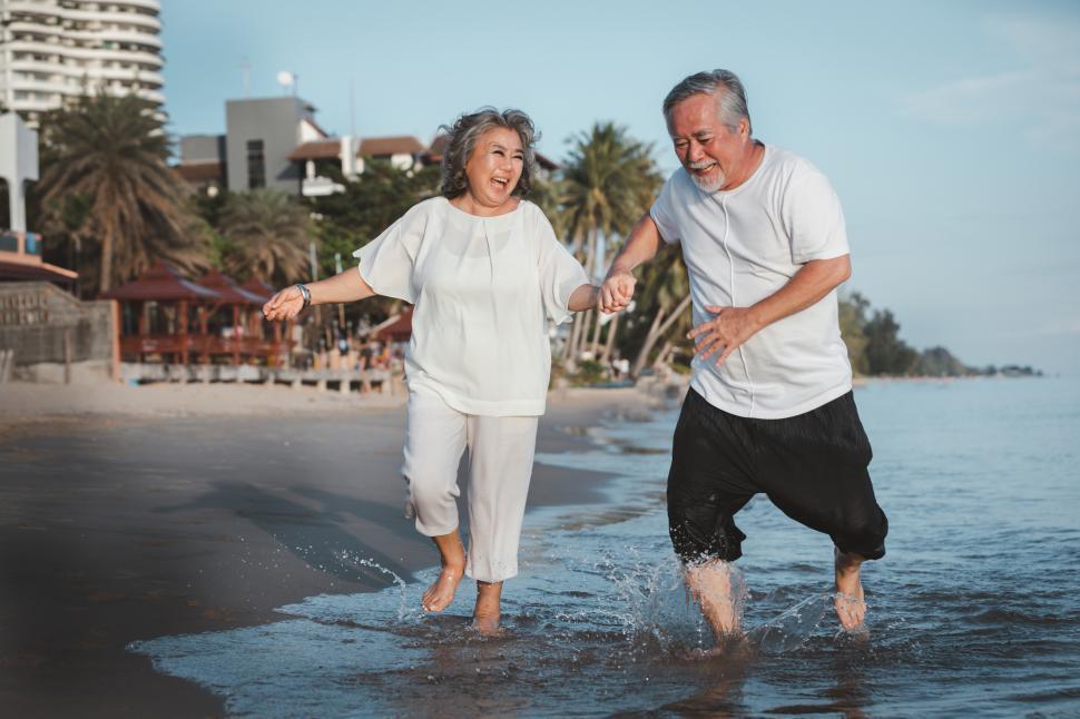 Free Image of The romantic senior couple playing in the surf 