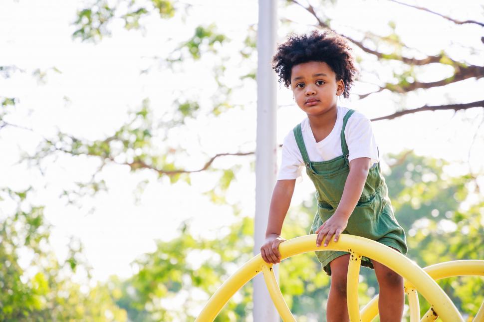 Free Image of Cute kid standing on playground equipment 