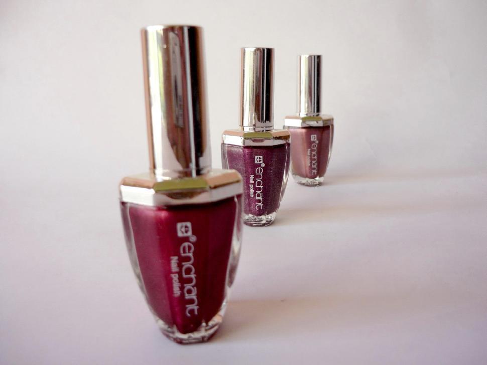 Free Image of Three Bottles of Nail Polish Arranged Neatly 