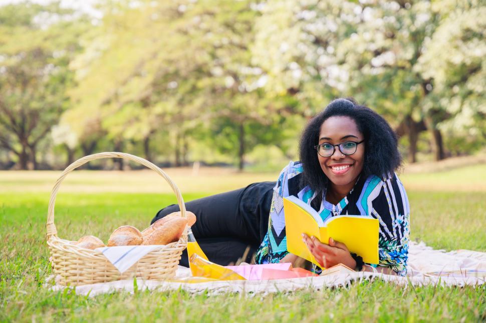 Free Image of Happy young woman reading an interesting book. 