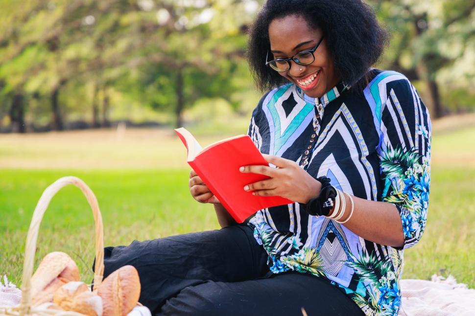 Free Image of Woman enjoying a book in the park 