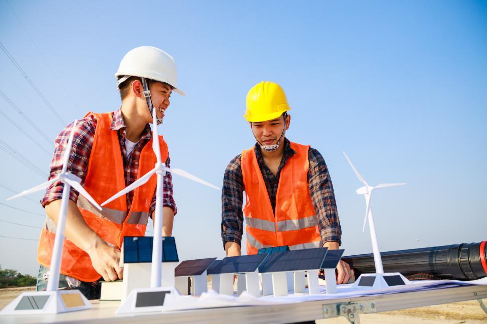 Download Free Stock Photo of Workers discuss wind energy installation 