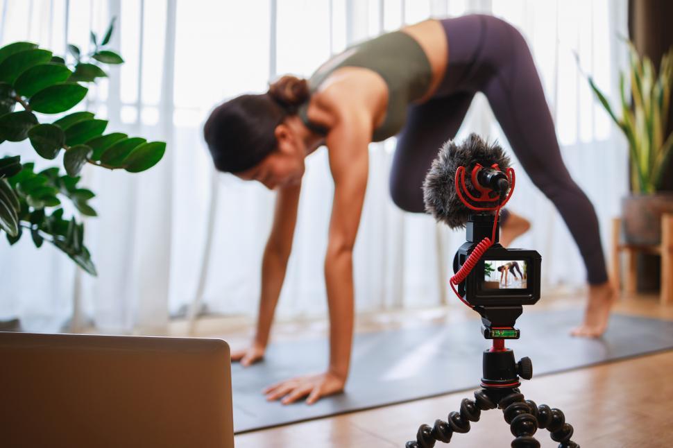 Free Image of Woman yoga teacher filming online class on video 