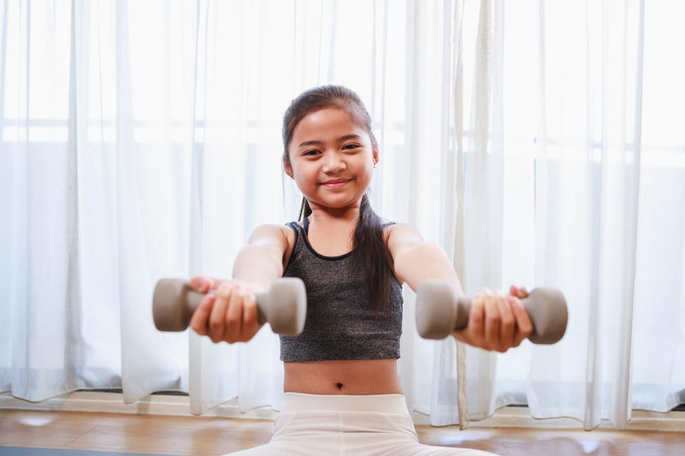 Free Image of Little Girl doing exercise at home 
