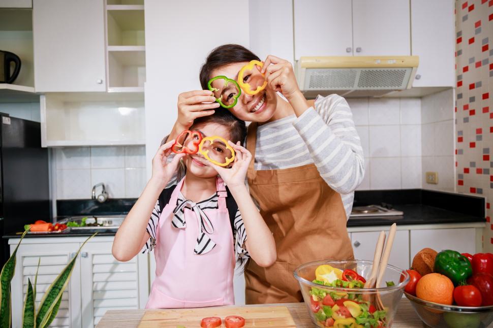 Free Image of Mother and little girl enjoy preparing the vegetables and fruit 