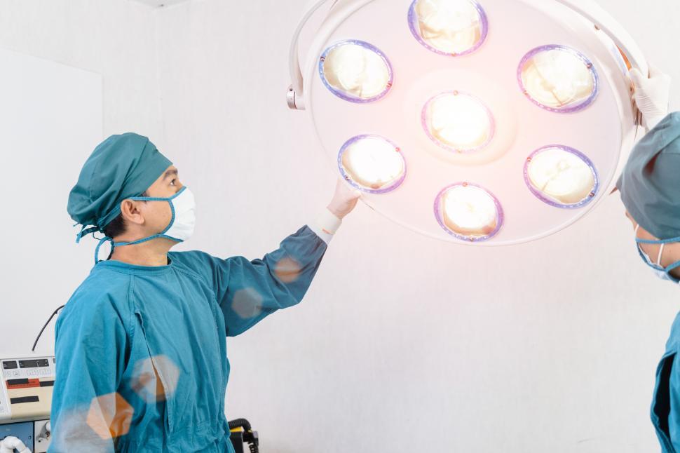 Download Free Stock Photo of surgeon preparing surgical lamps in the operating room 