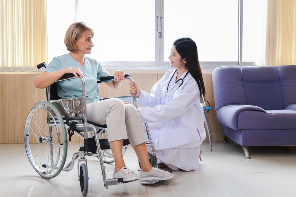 Free Image of Provider speaks with woman in wheelchair 
