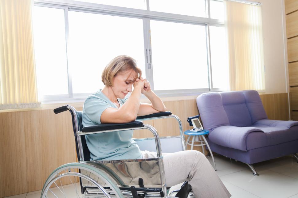 Free Image of Woman waits anxiously in wheelchair 