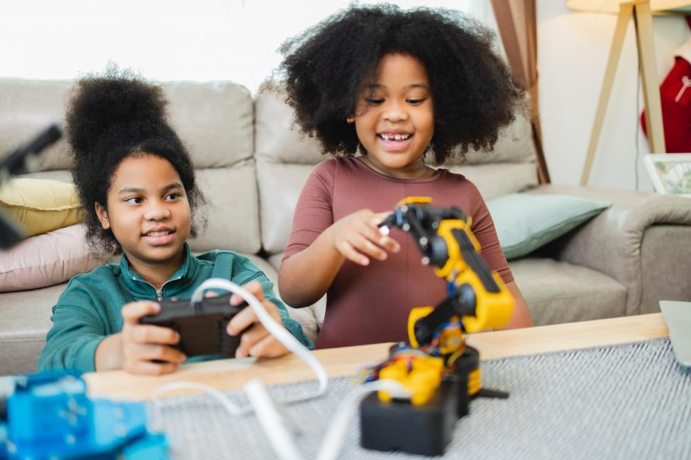 Free Image of Two girls experiment with robotics kit 