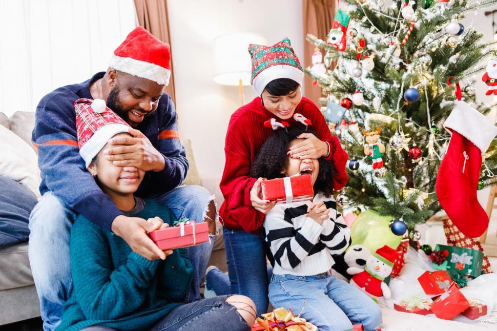 Free Image of Family surprising kids with a gift on Christmas day. 