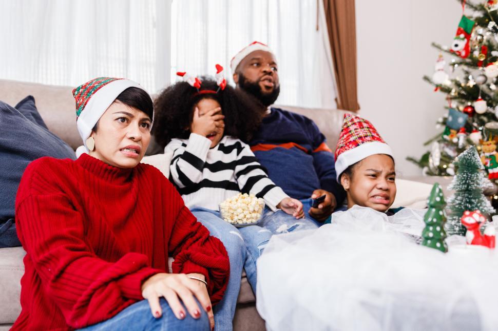 Free Image of Family cringing watching holiday television together 